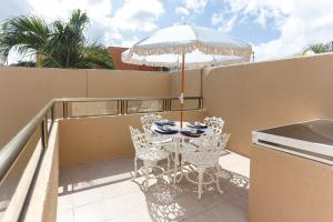 a patio with a table and chairs and an umbrella at Downtown Villa for 7 guests, access to pool! in Cancún