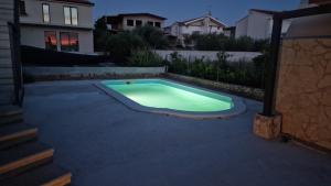 a swimming pool in the middle of a yard at Relax House Kanica in Zaglavice