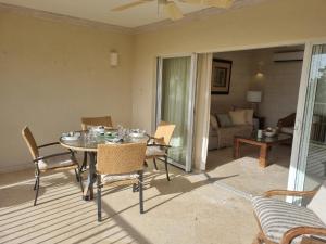 a dining room with a table and chairs at Royal Apartments 1 bedroom apartment sea views in Saint James +11 photos