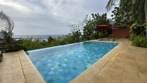 a swimming pool with a view of the ocean at Hotel Acantilado de La Tierra by On vacation in San Andrés +22 photos
