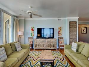 a living room with two couches and a flat screen tv at Beach Colony East #15A in Perdido Key