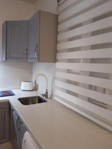 a kitchen with a sink and a counter top at Casa Rural "Entre Costuras" in Setenil +7 photos