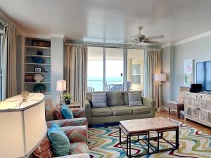 a living room with a couch and a tv at Beach Colony East #15A in Perdido Key