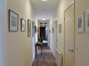 a hallway with a table and pictures on the walls at Quartermasters in Brancepeth +4 photos