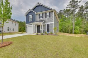 a home with a blue house and a yard at Cozy Oasis Vacation Home in Vass with Gas Grill! in Vass