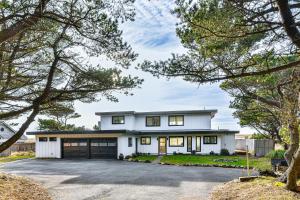 a white house with a driveway at 3-Acre Oceanfront Home Game Room and Fire Pit! in Warrenton