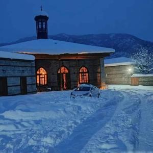 a car parked in the snow in front of a building at Lahij Ismayilov Hotel in İsmayıllı +15 photos