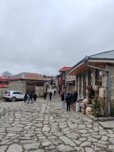 a group of people walking down a stone street at Lahij Ismayilov Hotel in İsmayıllı
