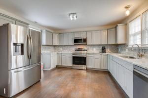a kitchen with white cabinets and a stainless steel refrigerator at Virginia Getaway Near Douthat State Park in Clifton Forge +23 photos