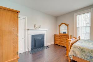 a bedroom with a fireplace and a bed and a dresser at Virginia Getaway Near Douthat State Park in Clifton Forge