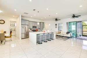 a kitchen and living room with white tile flooring at Day Trip to Fort Myers Beach Pet-Friendly Home! in Lehigh Acres