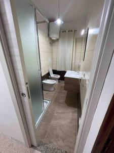a bathroom with a toilet and a sink and a shower at Casa Relax in Palmi +7 photos