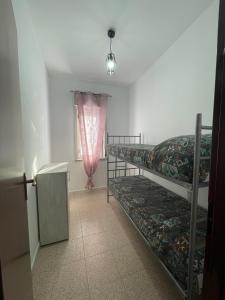 a room with two bunk beds and a window at Casa Relax in Palmi