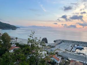 a view of a beach and the ocean at sunset at Casa Relax in Palmi