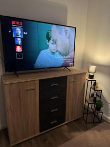a flat screen tv sitting on top of a entertainment center at Schöne Wohnung im Herzen Jülichs in Jülich