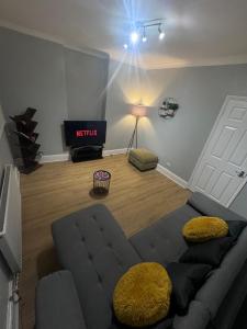 a living room with a couch in front of a door at Stylish 2-Bed Garden Flat, 5 Mins to Brixton in London