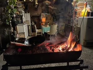 a kitchen with a fire pit in the middle of a room at labalade roulotte in Marsac