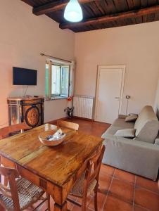a living room with a wooden table and a couch at Home Sweet Home Galatro in Galatro