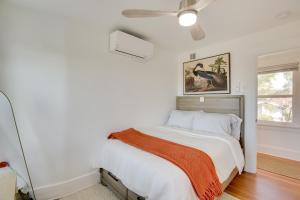 a bedroom with a bed with a bird picture on the wall at 1 Mi to Balboa Park Apt with Furnished Patio! in San Diego