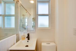 a white bathroom with a sink and a toilet at 1 Mi to Balboa Park Apt with Furnished Patio! in San Diego +18 photos