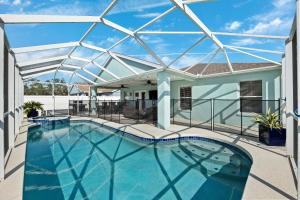 a large swimming pool with a glass roof at Saltwater Pool and Spa at Home in Bradenton in Bradenton