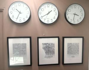 four clocks are hanging on a wall with pictures at A07 MASTER Suite Cocina Terraza Companies Work Teams 1-2 PAX in Cuautitlán Izcalli