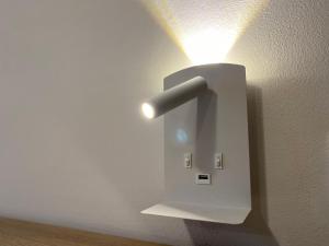 a light on a wall with a light on it at Casa di Gabry in Gradisca dʼIsonzo