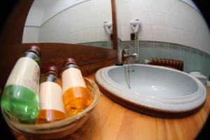 a bowl of bottles on a table next to a sink at Hospedería Bodas de Camacho in Munera +122 photos