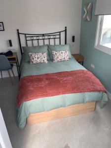 a bedroom with a large bed with a wooden headboard at Torre de Santa María in Utrera