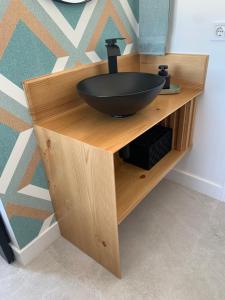 a wooden counter with a black sink on it at Torre de Santa María in Utrera
