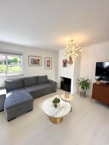 a living room with a couch and a table at Vilamoura Modern House in Quarteira