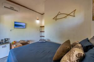 a bedroom with a bed with a fish on the wall at Bahia Soul - Kawai Suítes - Taipu de Fora - Península de Maraú in Marau