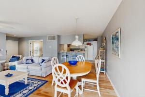 a living room with a table and a couch at Sea Colony - 55054 Pine Lake Dr in Bethany Beach