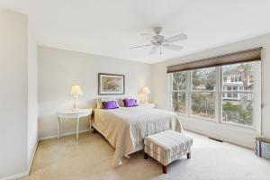 a bedroom with a bed with purple pillows and a window at Sea Colony - 55054 Pine Lake Dr in Bethany Beach +24 photos