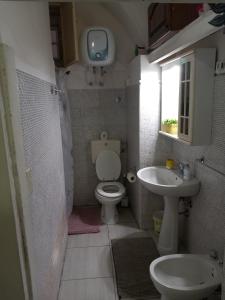 a small bathroom with a toilet and a sink at La civita 1 in Catania +25 photos