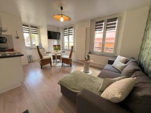 a living room with a couch and a table at Gîte Ripcup au coeur de Ribeauvillé in Ribeauvillé