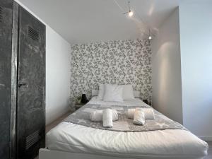 a bedroom with a bed with two pillows on it at Gîte Ripcup au coeur de Ribeauvillé in Ribeauvillé +20 photos