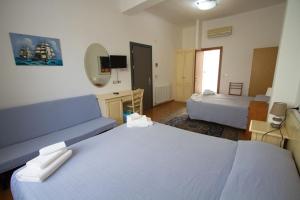 a hotel room with two beds and a mirror at Hotel Marinella in Celle Ligure