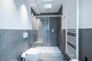 a bathroom with a shower and a toilet in it at Vittoria Apt Luxury e Design in Duomo in Brescia