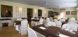 a banquet hall with tables and white chairs at Hotel Marinella in Celle Ligure +87 photos