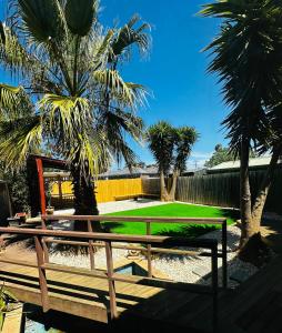 a park with palm trees and a picnic table at Werribee 3 BR Holiday Home in Werribee
