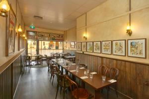 a dining room with wooden tables and chairs at Shamrock Hotel Kyneton in Kyneton