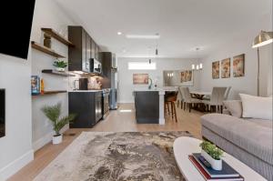 a living room and kitchen with a couch and a table at The Modern Muse Art Home in Wheat Ridge