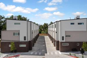 a row of buildings in a parking lot at The Modern Muse Art Home in Wheat Ridge