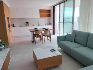 a living room with a couch and a table at Summer Days in Lagos