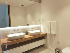 a bathroom with two sinks and a mirror at Summer Days in Lagos