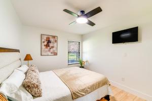 a bedroom with a bed and a ceiling fan at Covered Patio and Private Yard Dallas Area Home in Irving