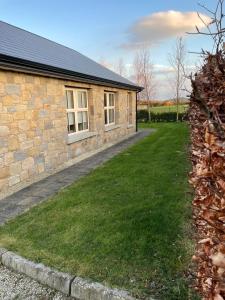 a house with a grass yard next to a building at Castle Gap Retreat in Jonesborough