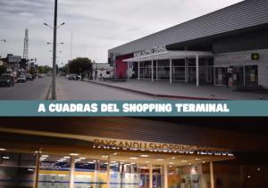 派桑杜Moderno apto con terraza a cuadras del Shopping Terminal的带有标牌的建筑,上面有标牌读取一个商场钟的购物终点