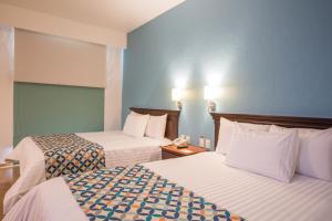 Voodi või voodid majutusasutuse HG Hotel toas